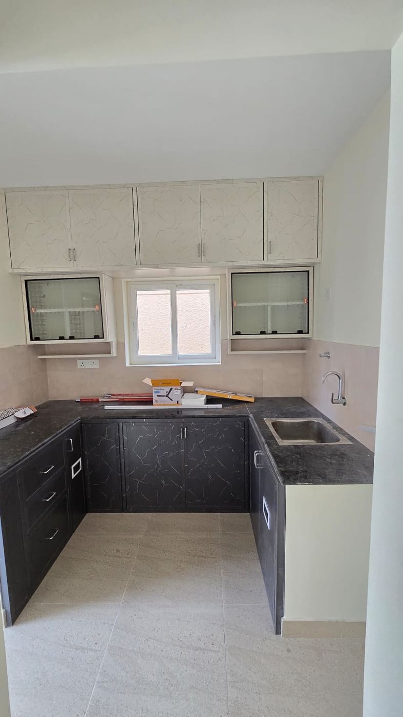 Off-white marble-look PVC/uPVC modular kitchen installed by No More Wood in Chennai