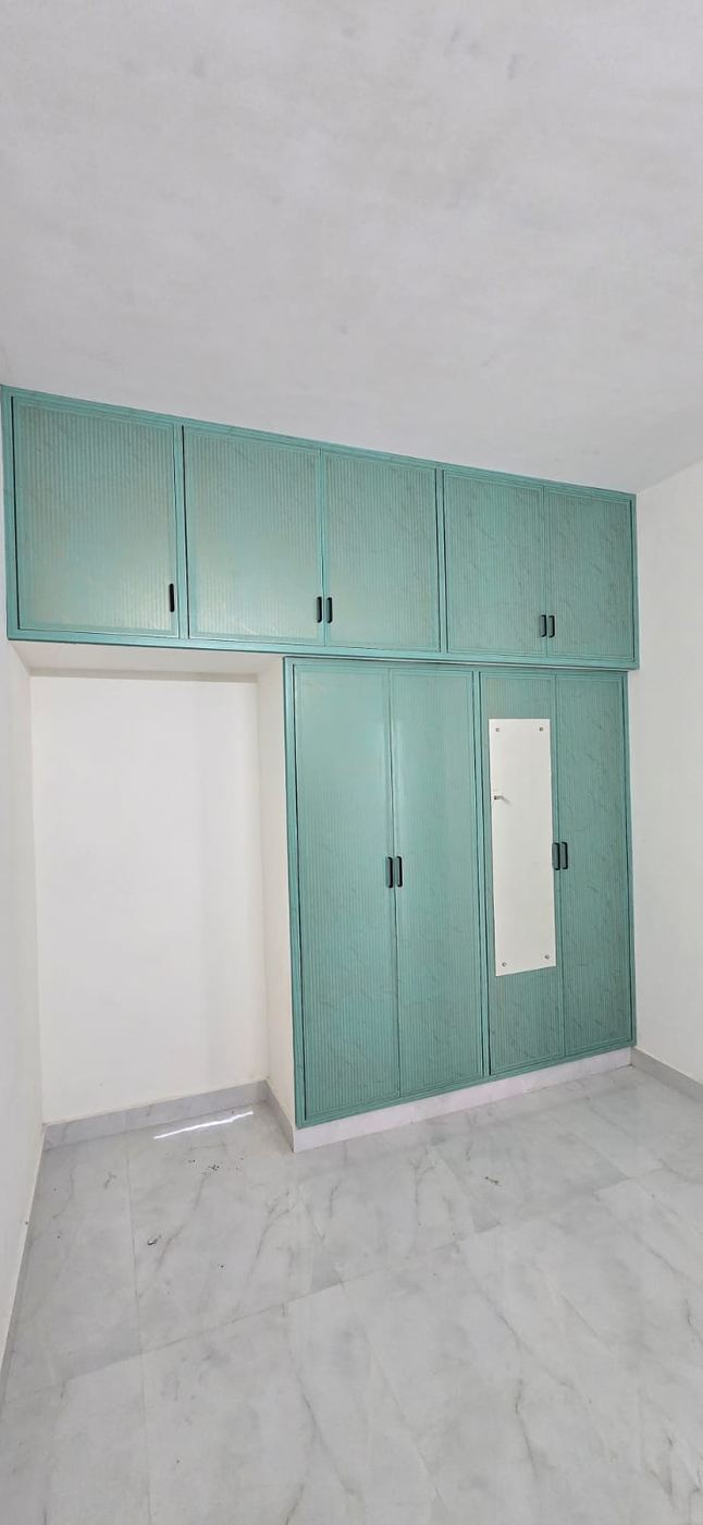Light grey PVC/uPVC bedroom wardrobe installed by No More Wood in Chennai